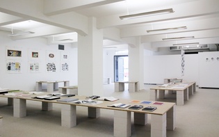 Installation view showcasing custom tables